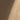 Close-up of a diagonal streak of light against a textured, shadowed wall. Cathedral of Dust